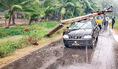 An electric pole fell on a car at Katrenikona on Monday during the landfall of Phethai.