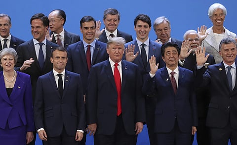 President Donald Trump, front center, stands with other world leaders as they pose for a group picture at the start of the G20 Leader's Summit inside the Costa Salguero Center in Buenos Aires, Argentina, Friday, Nov. 30, 2018. | AP