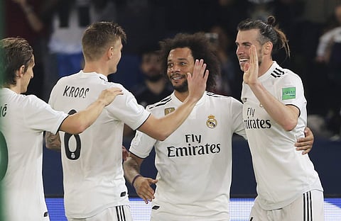 Real Madrid's midfielder Gareth Bale, right, celebrates after scoring his side's third goal during the Club World Cup semifinal soccer match between Real Madrid and Kashima Antlers at Zayed Sports City stadium in Abu Dhabi, United Arab Emirates, Wednesday