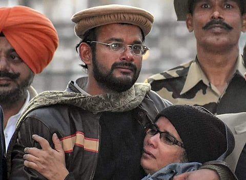 Hamid Nihal Ansari embracing his mother after his return (Photo | PTI)