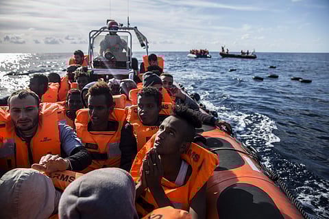 igrants sit in a rubber dinghy after Proactiva Open Arms, a Spanish NGO, spotted and rescued them in the Central Mediterranean Sea (Photo | AP)