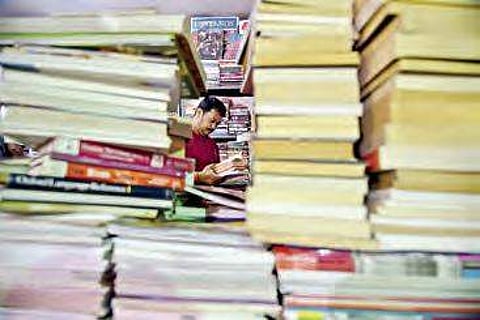 A man browses through books at book fair (FIie Photo| EPS/R Satish Babu)