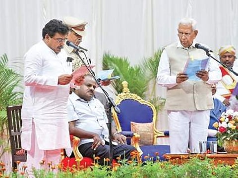The new ministers were administered the oath of office and secrecy at the Glass House at Raj Bhavan by Governor Vajubhai Vala on Saturday evening. (Photo | EPS)