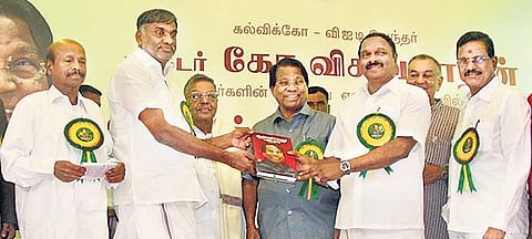 Commercial Taxes Minister K C Veeramani releasing the book ‘Stars and Saplings’ at the 80th birth anniversary celebration of G Viswananthan (centre), founder and chancellor of VIT, in Vellore on Sunday | Express