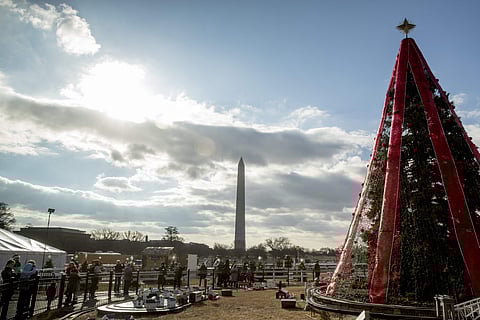 Visitors to the National Christmas Tree on the Ellipse look at holiday decorations as National Park Service employees briefly open the venue before quickly having to close again due to electrical problems, Monday, Dec. 24, 2018, in Washington. (Photo | AP