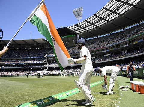 India's Cheteshwar Pujara and Mayank Agarwal enter the ground after lunch on day one of the third cricket test between India and Australia in Melbourne. (Photo | AP)