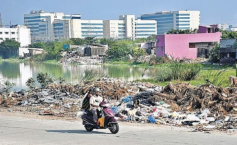 The periphery of the lake is strewn with garbage and heaps of construction waste Martin Louis