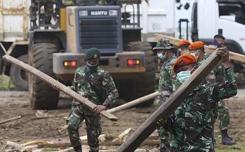 Soldiers remove debris from a damaged house in the tsunami-hit village of Carita, Indonesia (Photo | AP)