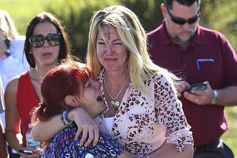 Parents wait for news of their loved ones after a mass shooting at Marjory Stoneman Douglas High School in Parkland, Fla., on Feb. 14, 2018. (Photo | AP)