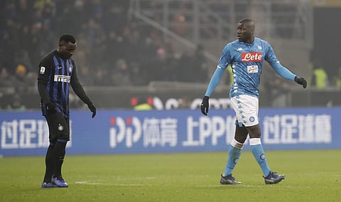 In this image taken on Wednesday, Dec.26, Napoli's Kalidou Koulibaly, right, leaves the pitch after receiving a red card from the referee 2018 during a Serie A soccer match between Inter Milan and Napoli, at the San Siro stadium in Milan, Italy. At left i