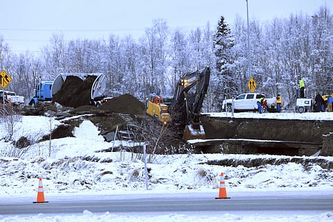 A dump truck and excavator work on a temporary fix of an off ramp that collapsed after an earthquake on Friday, Nov. 30, 2018, in Anchorage, Alaska. (Photo | AP)