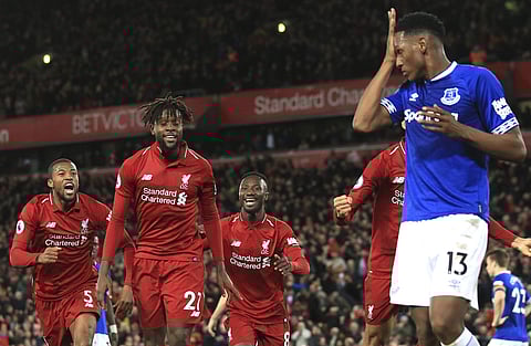 Liverpool forward Divock Origi, second from left, celebrates after scoring his side's first goal during the English Premier League soccer match between Liverpool and Everton at Anfield Stadium in Liverpool. (Photo | AP)