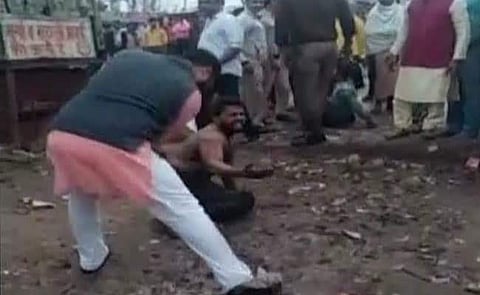 Saurabh Jha, an associate of Aam Aadmi Party MLA Rituraj Govind, is seen thrashing a boy named Vikas, who was allegedly involved in molesting a woman. (Video screengrab)