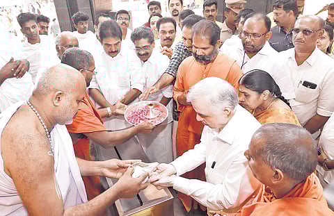 Governor P Sathasivam being presented with prasadam after he offered prayers at the Mahasamadhi at Sivagiri Math on Sunday.