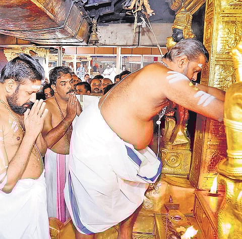 Melsanthi Vasudevan Nampoothiri opening the Sreekoil of Sabarimala Lord Ayyappa temple in the presence of Thantri Kandararu Rajivararu on Sunday, marking the beginning of the Makaravilakku festival season
