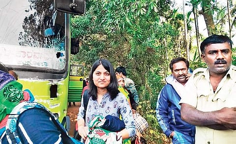 Passengers wait outside the bus in Arebail, after their near-death experience. The bus kept ramming the truck ahead of it, but came down the road safely | Express