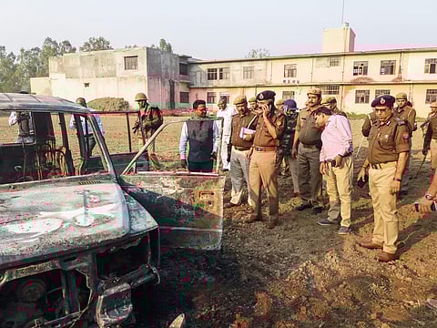 UP cops inspect after several vehicles were set on fire by a mob during a protest over the alleged illegal slaughter of cattle in Bulandshahr Monday. (File photo | PTI)