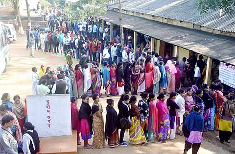 Voters stand in a queue at a polling station during the 1st phase of the panchayat elections. (Photo|PTI)