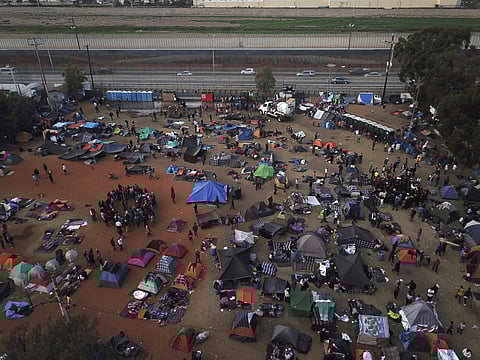 Central American migrants gather at a temporary shelter, near barriers that separate Mexico and the United States, in Tijuana, Mexico. (Photo | AP)