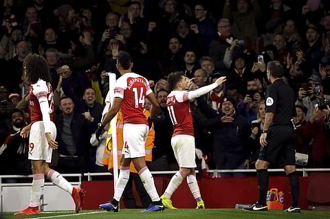 Arsenal's Lucas Torreira, centre left, celebrates scoring his side's first goal of the game, during the English Premier League soccer match between Arsenal and Huddersfield, at the Emirates Stadium, London, Saturday, Dec. 8, 2018. | AP