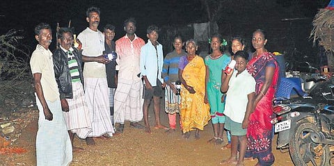 The villagers of Pazhayatrankarai stand with mobile phone torch light as they endure over 20 days without power in the aftermath of Gaja | Antony Fernando