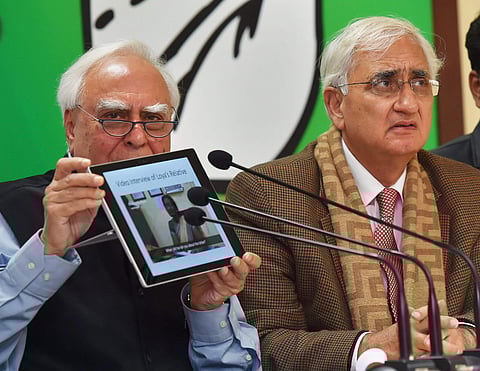 Congress leader Kapil Sibal speaks during a press conference regarding late Judge Loya's case as Salman Khurshid looks on in New Delhi on Wednesday. | PTI