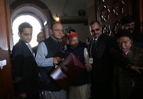 Union Finance minister Arun Jaitley holds a briefcase containing federal budget documents as he arrives to present the budget in Parliament house accompanied by MOS Finance Shiv Pratap Shukla in New Delhi on Thursday. (EPS | Shekhar Yadav)