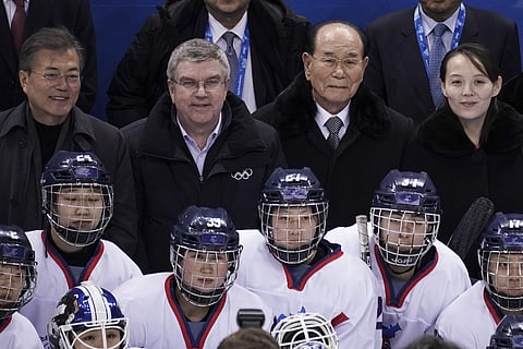 South Korean President Moon Jae-in, IOC president Thomas Bach, North Korea's nominal head of state Kim Yong Nam and Kim Yo Jong, sister of North Korean leader Kim Jong Un, pose for photos with players after the preliminary round of the women's hockey game