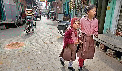 A sense of fear can be seen in the eyes of two schoolgirls at Vir Abdul Hamir Chowk in Kasganj. The remains of a rangoli of the Tricolour can be seen on the road where the clashes erupted on Republic Day. (Bottom right) Residents now buy ration from shops