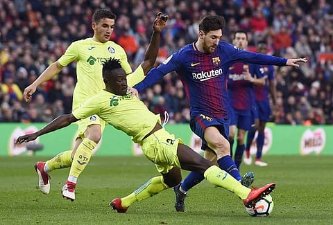 Getafe's Togolese defender Dakonam Djene (2L) vies with Barcelona's Argentinian forward Lionel Messi during the Spanish league football match between FC Barcelona and Getafe CF. | AFP
