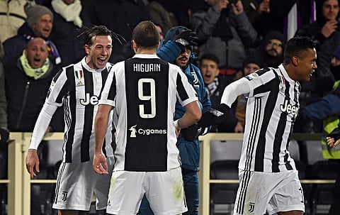 Juventus' Federico Bernardeschi, left, celebrates with teammate Gonzalo Higuain after scoring during a Serie A soccer match against Fiorentina. | AP