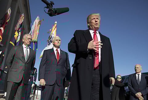 President Donald Trump, joined by Defense Secretary Jim Mattis, left, Vice President Mike Pence, second from left, and White House Chief of Staff John Kelly, right, speaks to the media as he arrives at the Pentagon, Thursday, Jan. 18, 2018. | AP