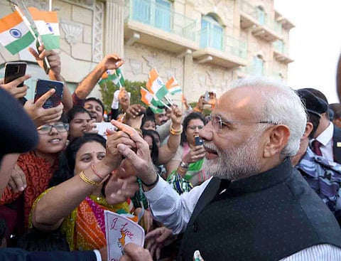 Prime Minister Narendra Modi meets Indian community people who enthusiastically welcomed him in Muscat Oman on Sunday. (PTI)