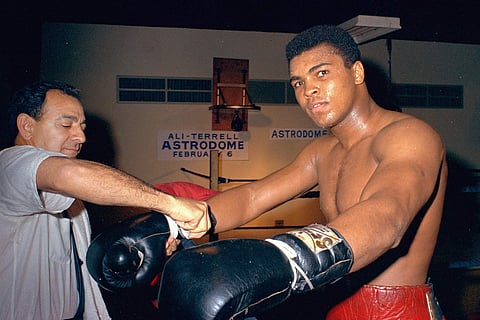 Muhammad Ali gets his gloves laced by trainer Angelo Dundee while training in Houston, Texas (File | AP)