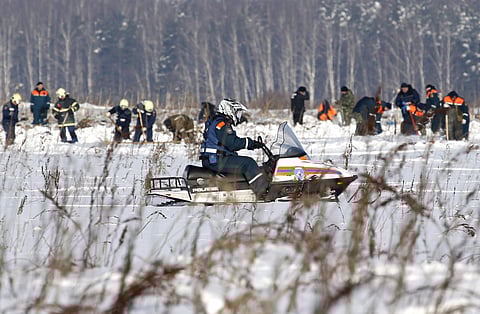 Russian Emergency officers work at the scene of the crash | AP