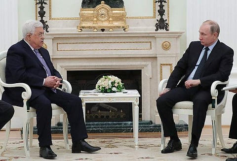 Russian President Vladimir Putin (R) talks to Palestinian leader Mahmud Abbas during their meeting at the Kremlin in Moscow. | AFP