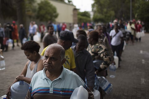 Residents wait in a queue to fill containers with water at a source for natural spring water in Cape Town. (File | AP)