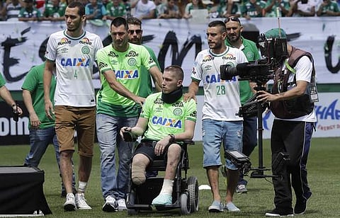 Chapecoense players Neto, left, goalkeeper Follmann, on the wheelchair, and Alan Ruschel, right, the three players that survived the air crash. (File | AP)