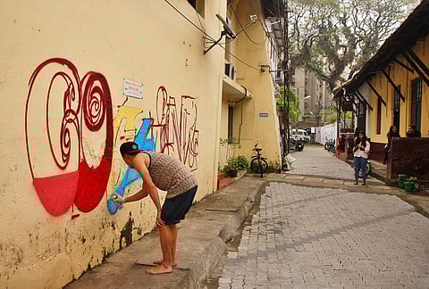 A foreign graffiti artist tries out his creation on the walls of Burgher Street in Fort Kochi during the 2016 Biennale. (File |EPS)