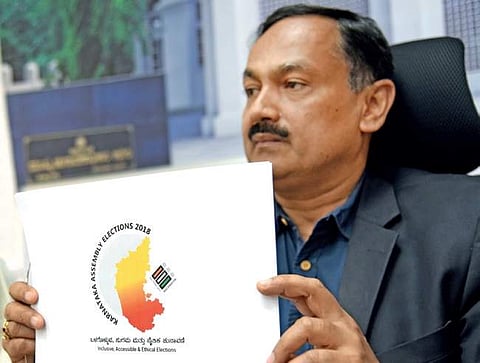 Sanjeev Kumar, Chief Election Officer, Karnataka, holds the logo designed for the assembly election-2018 on Saturday | Nagaraja Gadekal