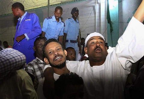 Family members welcome their loved ones after Sudan released dozens of opposition activists who were arrested last month when authorities cracked down on protests against rising food prices, outside the Kobar prison in north Khartoum. | AFP