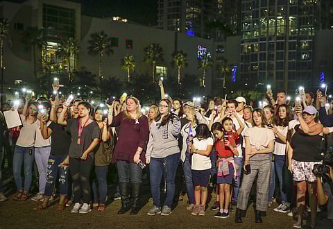 In Florida, People raise their lights during a vigil at Curtis Hixon Park | AP