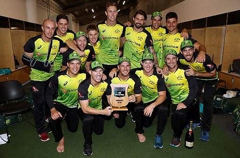 Australia's cricket players celebrate after winning the final Twenty20 Tri Series international cricket match between New Zealand and Australia at Eden Park in Auckland on February 21, 2018. | AFP