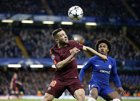 Barcelona's Jordi Alba, left, heads the ball as Chelsea's Willian looks on. Barca went on to dominate possession, but the visitors lacked penetration before the break and were lucky to go in level at half-time. | AP