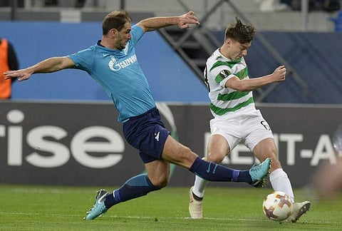Zenit Saint Petersburg's defender from Serbia Branislav Ivanovic (L) vies with Celtic's Scottish midfielder Ross McLaughlin during the Europa League Round of 32 second leg football match. | AFP
