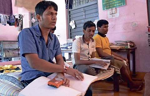Visually challenged students of Bhima Bhoi School for the Blind preparing for the exam