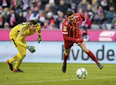 Bayern's Robert Lewandowski, right, runs past Hertha goalkeeper Rune Jarstein during the German Bundesliga soccer match between FC Bayern Munich and Hertha BSC Berlin in Munich, southern Germany. | AP