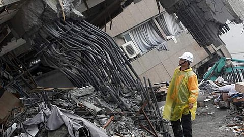 An official inspects the failed rebar foundation pillars during a continued search operation at an apartment building that collapsed after a strong earthquake in Taiwan on April 3.