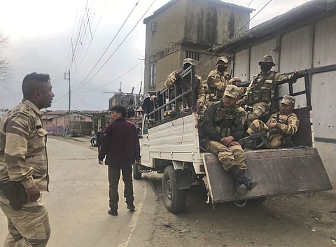 Nagaland police personnel keep guard outside a polling station during the Nagaland state legislature elections in Kohima village, Tuesday - AP Photo