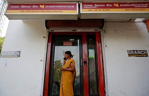 A woman speaks on her mobile phone outside a Punjab National Bank (PNB) branch. (Photo | Reuters)